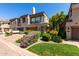Attractive townhome with a two-car garage, complemented by colorful landscaping and a green lawn at 7400 E Gainey Club Dr # 203, Scottsdale, AZ 85258