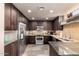 This kitchen features stainless steel appliances, wooden cabinetry, and sleek countertops at 7400 E Gainey Club Dr # 203, Scottsdale, AZ 85258