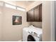 Bright laundry room featuring a modern washer and dryer, and built in cabinets at 7400 E Gainey Club Dr # 203, Scottsdale, AZ 85258