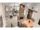 Open-concept living room featuring a stone fireplace, dining area, and stylish decor at 7400 E Gainey Club Dr # 203, Scottsdale, AZ 85258