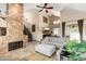 Open-concept living area with a floor-to-ceiling stone fireplace, modern finishes, and cozy seating at 7400 E Gainey Club Dr # 203, Scottsdale, AZ 85258
