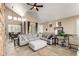 Bright and airy living room featuring a vaulted ceiling, comfortable furniture, and a dining area at 7400 E Gainey Club Dr # 203, Scottsdale, AZ 85258