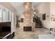 Inviting living area with a stone fireplace, tile floors, and an open layout for entertaining at 7400 E Gainey Club Dr # 203, Scottsdale, AZ 85258