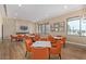 Inviting community room with a cozy fireplace, TV, tables, and comfortable seating for residents at 7400 E Gainey Club Dr # 203, Scottsdale, AZ 85258