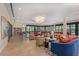 Spacious lounge area featuring comfortable seating arrangements, a library, and lots of natural light at 7400 E Gainey Club Dr # 203, Scottsdale, AZ 85258
