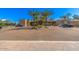 Exterior view of parking lot with lush landscaping, palm trees, and the building's entrance at 7400 E Gainey Club Dr # 203, Scottsdale, AZ 85258