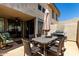 This comfortable outdoor seating on the patio features dining table, chairs, and a grill for outdoor entertainment at 7400 E Gainey Club Dr # 203, Scottsdale, AZ 85258