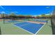 Bright and sunny day on the community pickleball courts with nice landscaping and fencing at 7400 E Gainey Club Dr # 203, Scottsdale, AZ 85258