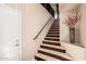 Elegant staircase with marble steps, a dark wood trim, and decorative vase at the landing at 7400 E Gainey Club Dr # 203, Scottsdale, AZ 85258