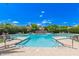 Well-maintained community swimming pool with lounge chairs and umbrellas on a bright and sunny day at 7400 E Gainey Club Dr # 203, Scottsdale, AZ 85258