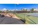 Tennis court with lights for evening play in a well-maintained community with shaded seating at 7400 E Gainey Club Dr # 203, Scottsdale, AZ 85258