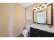 Neat half bathroom with modern fixtures and a dark vanity offering storage at 7658 W Boca Raton Rd, Peoria, AZ 85381