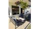 Under the covered patio featuring a cozy seating arrangement and hanging flowers at 7658 W Boca Raton Rd, Peoria, AZ 85381
