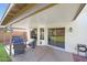 View of a covered patio showing seating, potted plants and access to large, grassy backyard at 7658 W Boca Raton Rd, Peoria, AZ 85381