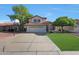 Charming two-story home featuring a red tile roof, spacious driveway with basketball hoop, and well-maintained landscaping at 7658 W Boca Raton Rd, Peoria, AZ 85381