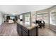 An open-concept kitchen features an island with granite countertops and a view to the living area and backyard at 7658 W Boca Raton Rd, Peoria, AZ 85381