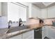 An updated kitchen features stainless steel appliances, granite countertops, and white tile backsplash at 7658 W Boca Raton Rd, Peoria, AZ 85381