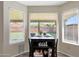 Breakfast nook with table and chairs in bay window offering backyard view with book shelves and decor at 7658 W Boca Raton Rd, Peoria, AZ 85381