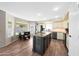 Bright kitchen featuring an island with granite countertops, wood-look tile floors, and stainless steel appliances at 7658 W Boca Raton Rd, Peoria, AZ 85381