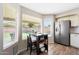 An eat-in kitchen area offers a view of the backyard, stainless steel refrigerator, and tile flooring at 7658 W Boca Raton Rd, Peoria, AZ 85381