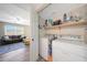 Convenient laundry room setup with shelving and direct access to the living room at 7658 W Boca Raton Rd, Peoria, AZ 85381