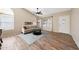 Bright living room featuring wood-look tile floors, neutral paint, a ceiling fan, and a cozy seating area at 7658 W Boca Raton Rd, Peoria, AZ 85381
