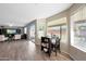 An open eat-in kitchen flows into a living space with tile flooring and a view of the backyard at 7658 W Boca Raton Rd, Peoria, AZ 85381