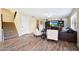 A cozy living room offers tile floors, comfortable seating, a staircase, and an entertainment center at 7658 W Boca Raton Rd, Peoria, AZ 85381