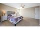 Comfortable main bedroom with carpet flooring, neutral walls, and a decorative headboard at 7658 W Boca Raton Rd, Peoria, AZ 85381