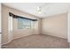 Neutral bedroom with a ceiling fan, carpet flooring, and a large window at 839 Leisure World --, Mesa, AZ 85206