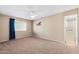 Spacious bedroom with neutral carpet, ceiling fan, and an adjacent ensuite bathroom at 839 Leisure World --, Mesa, AZ 85206