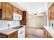 Functional kitchen equipped with white appliances, ample cabinet space, and easy access to the connecting rooms at 839 Leisure World --, Mesa, AZ 85206