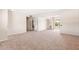 Bright living room with neutral carpet, access to a balcony, and multiple doorways for easy movement throughout the house at 839 Leisure World --, Mesa, AZ 85206