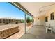 A covered patio features seating, a ceiling fan, and views of the yard at 839 Leisure World --, Mesa, AZ 85206