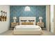Inviting bedroom highlighting a bed, bedside tables with lamps, and guitars displayed on the patterned wall at 9541 W Pinchot Ave, Phoenix, AZ 85037