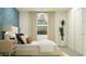 Serene bedroom showcasing a bed, patterned accent wall, and a window for natural light at 9541 W Pinchot Ave, Phoenix, AZ 85037