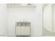 Clean, bright laundry room with a folding rack and storage shelf for organized convenience at 9541 W Pinchot Ave, Phoenix, AZ 85037