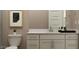 Neutral bathroom featuring a white cabinet, a white toilet, and a coordinated wall art at 9633 W Monterey Way, Phoenix, AZ 85037