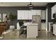 Bright kitchen featuring white cabinets, stainless steel appliances, and an island with seating at 9633 W Monterey Way, Phoenix, AZ 85037
