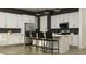Modern kitchen features white cabinets, stainless steel appliances, and a central island with seating at 9633 W Monterey Way, Phoenix, AZ 85037