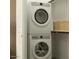A compact laundry room includes a stackable white washer and dryer, plus shelf at 9633 W Monterey Way, Phoenix, AZ 85037