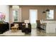 Comfortable living room with a plush couch, a modern TV, and an inviting breakfast bar for casual dining at 9633 W Monterey Way, Phoenix, AZ 85037