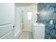 Stylish bathroom featuring patterned wallpaper, bathtub with shower, and vanity with storage at 1512 E Cypress St, Phoenix, AZ 85006