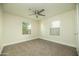 Clean and bright bedroom featuring two windows, neutral carpet, and a ceiling fan at 1512 E Cypress St, Phoenix, AZ 85006