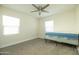 Simple bedroom with neutral walls, two windows, and carpet flooring; mattress on frame at 1512 E Cypress St, Phoenix, AZ 85006