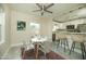 Bright dining area open to the kitchen featuring modern chairs, a chic table, and updated appliances at 1512 E Cypress St, Phoenix, AZ 85006