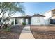 Charming single story home featuring a welcoming walkway, rock landscaping, and a light blue front door at 1512 E Cypress St, Phoenix, AZ 85006