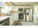 Bright kitchen featuring stainless steel appliances, white cabinets, and stylish tile flooring at 1512 E Cypress St, Phoenix, AZ 85006