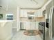 Well-lit kitchen with modern appliances, white cabinetry, tile backsplash, and tile flooring at 1512 E Cypress St, Phoenix, AZ 85006