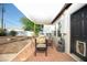 Covered patio area with brick flooring, a dining table with seating, and water feature at 1512 E Cypress St, Phoenix, AZ 85006